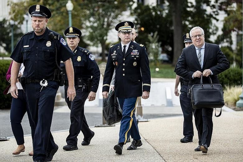 Army Lieutenant-Colonel Alexander Vindman (in military uniform) arriving on Capitol Hill on Tuesday to testify in the House of Representatives inquiry into whether to impeach the President.