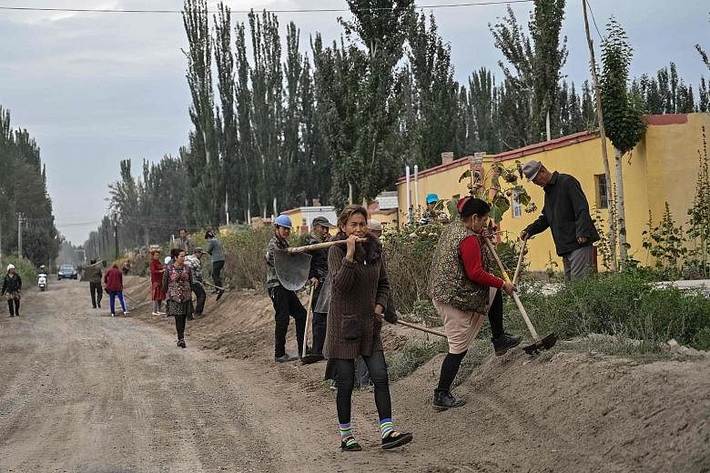 A village (above) in Xinjiang where Uighurs live. China has been condemned for setting up complexes in Xinjiang that it describes as "vocational training centres".