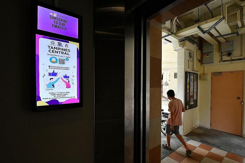 A digital display panel inside a lift at Block 842 Tampines Street 82. Several town councils have already installed about 8,700 such panels in the common areas of HDB blocks. ST PHOTO: LIM YAOHUI