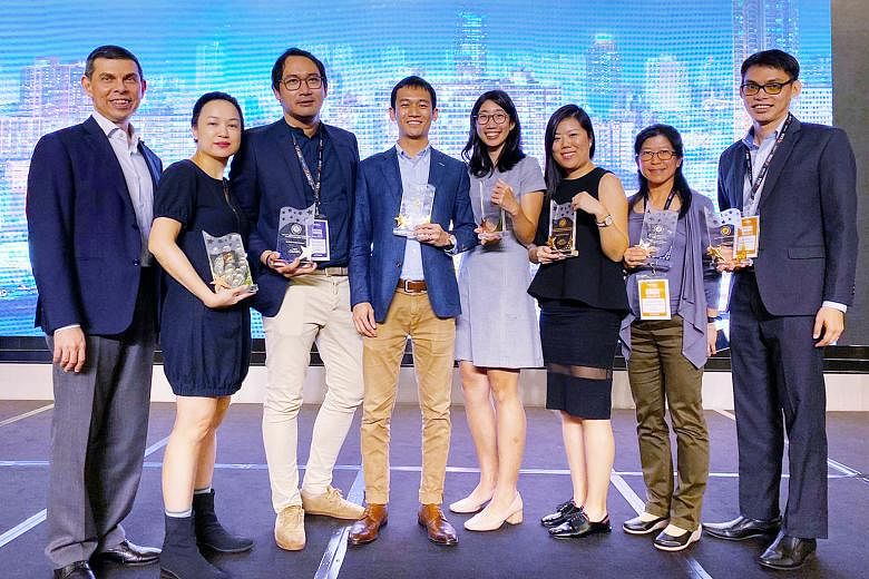 (From left) Straits Times editor Warren Fernandez with award recipients ST senior executive content producer Denise Chong; Stomp editor Azhar Kasman; product manager in digital media products Joash Yeo; business development manager in the Chinese Med