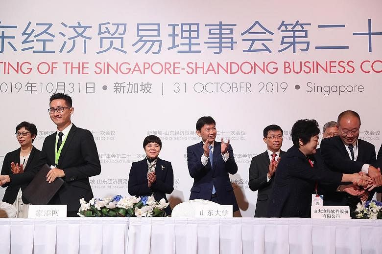 Senior Minister of State for Trade and Industry Chee Hong Tat and Shandong Vice-Governor Ren Airong (both centre) at yesterday's meeting of the Singapore-Shandong Business Council, which they co-chair. A total of 12 agreements were signed between Sin