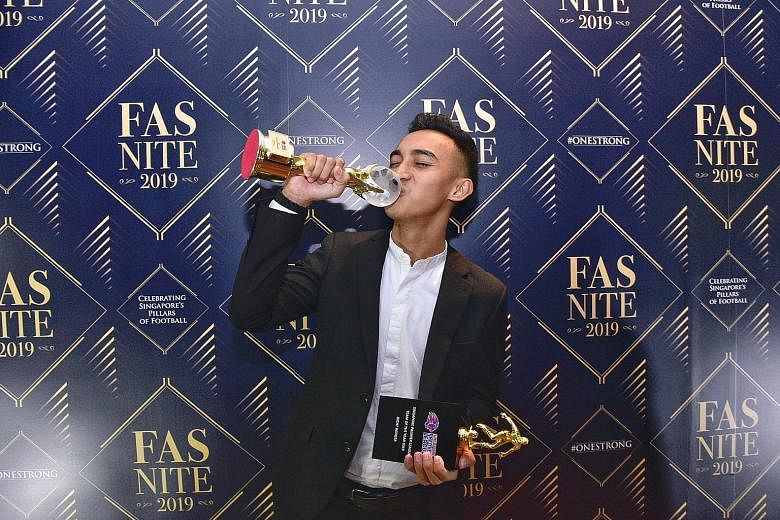 Hougang's Faris Ramli celebrating with his two trophies for winning the Player of the Year award and being named in the SPL Team of the Year at yesterday's FAS Nite 2019. ST PHOTOS: DESMOND WEE