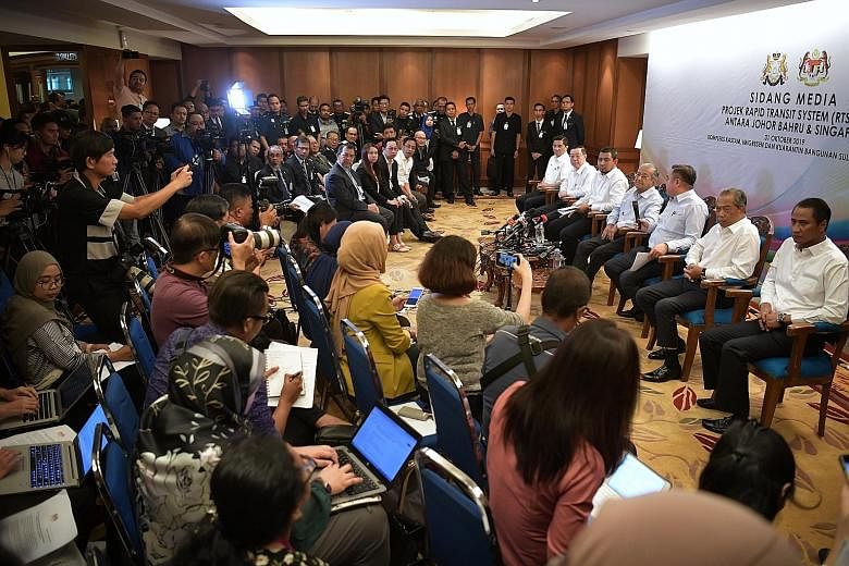 Malaysian Prime Minister Mahathir Mohamad (centre) holding a press conference at the Bangunan Sultan Iskandar Customs, Immigration and Quarantine Complex in Johor Baru yesterday with (from left) Economic Affairs Minister Azmin Ali, Finance Minister L
