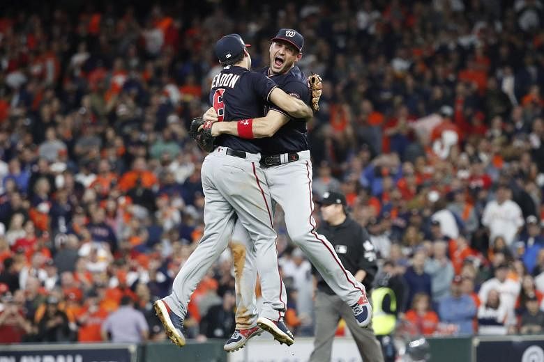 Washington Nationals players Anthony Rendon (left) and Ryan Zimmerman leaping in celebration after defeating the Houston Astros 6-2 in Game 7 of the MLB World Series in Houston, Texas. PHOTO: EPA-EFE