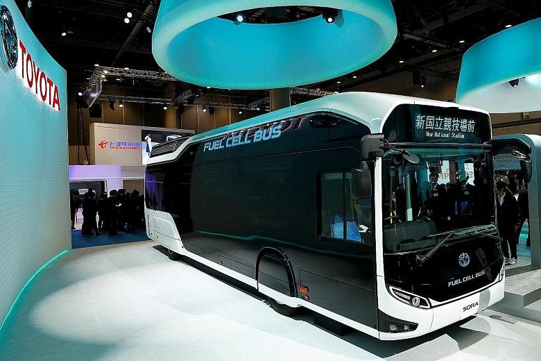 Toyota is deploying hydrogen fuel cell Sora buses (above) and the e-Palettes (right) to shuttle visitors between venues during the Games next year. Toyota will use field support robots to retrieve thrown javelins during the Tokyo Olympics and Paralym