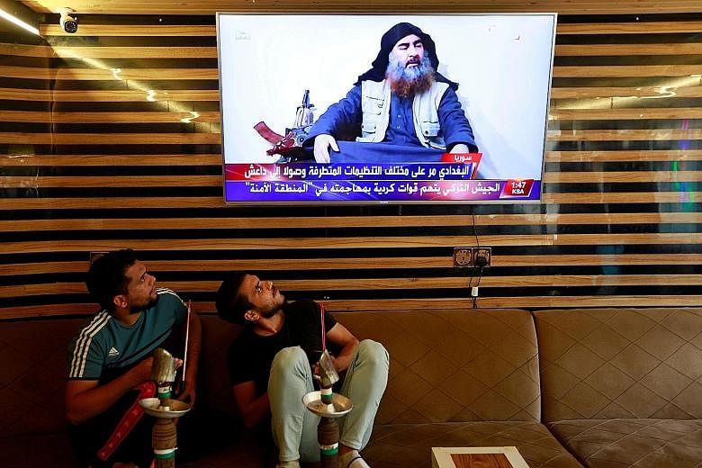 Iraqi youth watching the news about the death of ISIS leader Abu Bakr al-Baghdadi during a raid by US forces last weekend. Asia News Network writers say his death, while arguably a boost for US President Donald Trump, does not mean the terror threat 