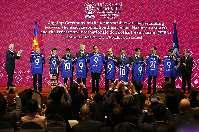 Fifa president Gianni Infantino (far left) and Asean Secretary-General Lim Jock Hoi (far right) at the Asean Summit in Bangkok, along with Asean leaders, including Prime Minister Lee Hsien Loong (fifth from left).