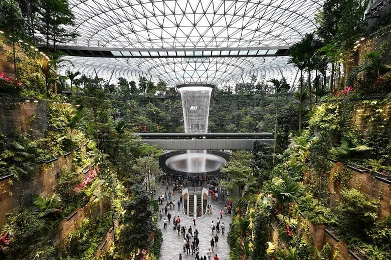 The expansion plans for Qatar's Hamad International Airport, unveiled in Doha two weeks ago, feature an indoor waterfall and massive gardens (above) that are strikingly similar to what Jewel Changi Airport (left) offers. PHOTOS: HAMAD INTERNATIONAL A