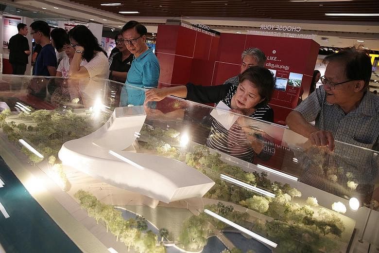 Members of the public viewing 3D models of the shortlisted Founders' Memorial designs at an exhibition at IMM in Jurong East yesterday. ST PHOTO: JASON QUAH
