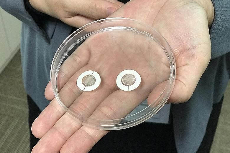 Dr Liu Yuchun, junior principal investigator at the National Dental Research Institute Singapore, holding the conventional needle for administering anaesthesia for dental procedures and the microneedle patch (close-up below) that her team has come up
