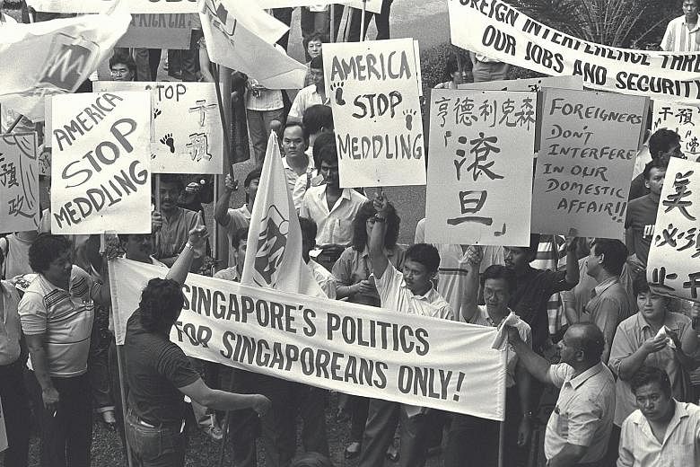Workers at an NTUC rally in 1988 to protest against US interference in Singapore politics. US diplomat Hank Hendrickson had encouraged a group of Singaporean lawyers to enter opposition politics and contest the elections. ST FILE PHOTO