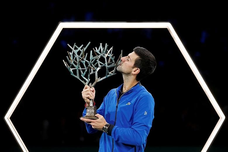 Serbia's Novak Djokovic celebrating his 34th Masters title in Paris on Sunday. His next target is the ATP Finals in London as the world No. 2 attempts to leapfrog Rafael Nadal at the top of the world rankings. PHOTO: REUTERS