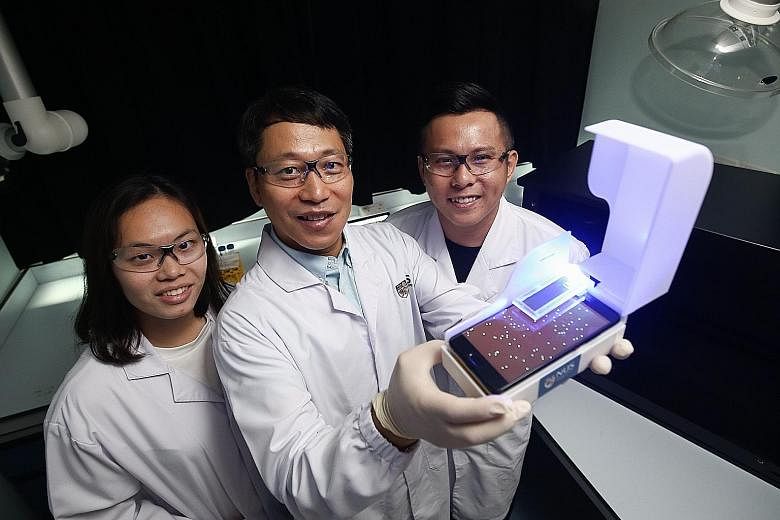 Assistant Professor Bae Sung-woo, flanked by master's student Elaine Chiang and doctoral student Thio Si Kuan, developed an easy-to-use device costing less than $300. Conventional methods can cost up to $100,000.