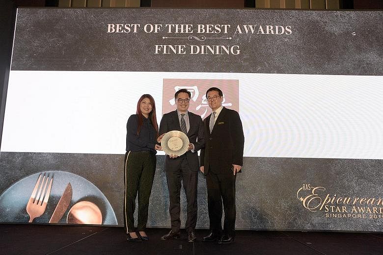 The woodfire grilled pork steak from Bedrock Bar & Grill. The restaurant in Somerset was named the Best Steak Restaurant at the RAS Epicurean Star Award gala yesterday. Mr Mervyn Koh (centre), managing director and country head of UOB Singapore, pres