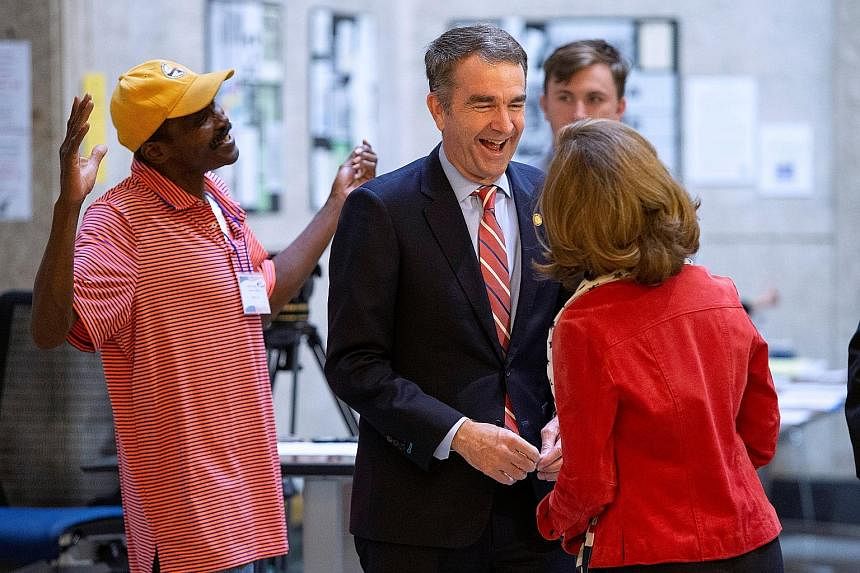 IN VIRGINIA Governor Ralph Northam, a Democrat, with his wife, Mrs Pamela Northam, after casting his vote in Richmond on Tuesday. PHOTO: REUTERS IN KENTUCKY Above: Governor Matt Bevin, a deeply unpopular Republican who refused to concede the election