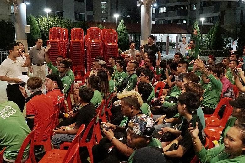 Minister for Social and Family Development Desmond Lee meeting a group of food delivery riders last night at his Meet-the-People Session in Jurong Spring. ST PHOTO: KHALID BABA