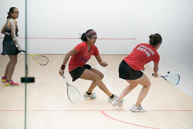 Singapore's Mao Shi Hui (centre) and Sherilyn Yang winning the jumbo doubles title at the Kuala Lumpur SEA Games in 2017. It was one of three gold medals won by the Singapore squash team. PHOTO: SPORT SINGAPORE