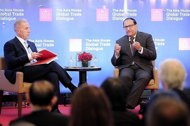 Minister-in-charge of Trade Relations S. Iswaran (right) said at yesterday's Asia House Global Trade Dialogue moderated by Asia House CEO Michael Lawrence that it is important to keep up the engagement with India. ST PHOTO: GAVIN FOO