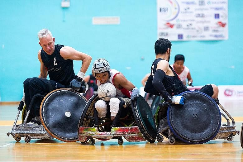 Team Indonesia's Mashuri fending off the European team on Thursday during the three-day Halcyon Agri International Wheelchair Rugby Tournament Super Series in Singapore. It ends today with two semi-finals at Toa Payoh Sports Hall and the medal matches at 