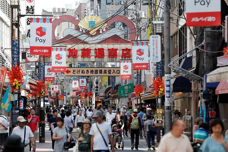 Japan's economic growth likely slowed to an annualised 0.8 per cent in July-September from 1.3 per cent in the second quarter, a Reuters poll showed this week. PHOTO: REUTERS