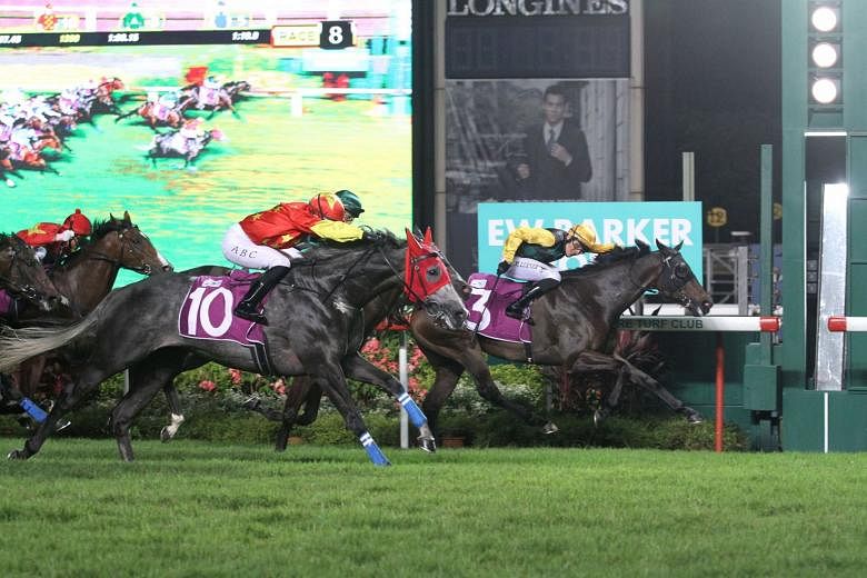 Fame Star holding on resolutely to stave off Grand Koonta (No. 10) in the $400,000 Group 2 EW Barker Trophy over 1,400m in Race 8 at Kranji last night. 