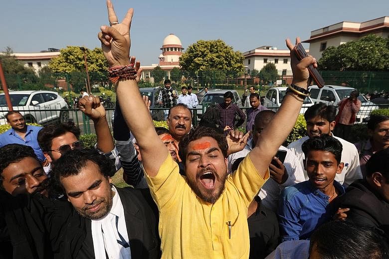 Hindu devotees outside the Supreme Court in New Delhi yesterday after the court awarded custody of a disputed site in Ayodhya to a government-appointed trust that will be made up of Hindu representatives. Legal conflict between Muslim and Hindu group