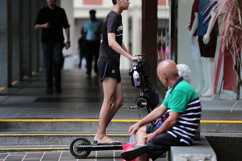 An e-scooter rider in Chinatown last Tuesday, the first day of the ban on e-scooters on public footpaths.