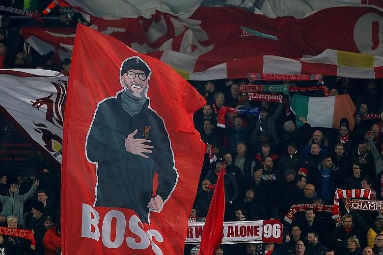 Liverpool fans holding up a banner of manager Jurgen Klopp before the Champions League match against Genk at Anfield on Wednesday. 