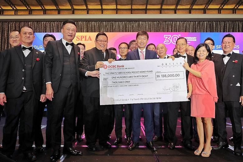 Senior Minister of State for Trade and Industry Chee Hong Tat (centre) at the 30th anniversary of the Singapore Plastic Industry Association, when SPIA donated $138,000 to The Straits Times School Pocket Money Fund (STSPMF). With Mr Chee are (from le