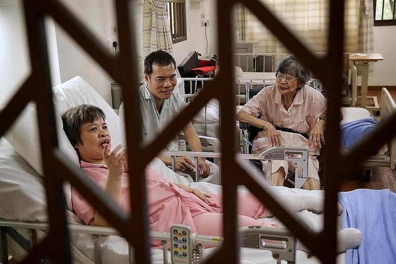Madam Ang Swee Huay (right), 91, with her son Cheong Poh Fatt, 56, and daughter Cheong Mee Choo, 57, at St Andrew's Nursing Home. Madam Ang now has stage three cancer, as well as dementia. Her son suffers from schizophrenia, while her daughter has po