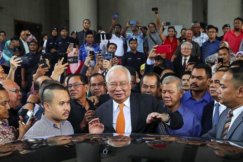 Former Malaysian prime minister Najib Razak leaving the Kuala Lumpur High Court complex yesterday. Najib has five court cases spanning 42 criminal charges for corruption and money laundering. PHOTO: EPA-EFE