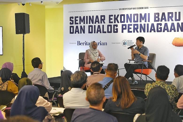 Senior Minister of State for Trade and Industry Chee Hong Tat speaking at the Berita Harian Future Economy Seminar and Dialogue at Singapore Polytechnic yesterday. With him was Berita Harian correspondent Shahida Sarhid, who was the moderator.