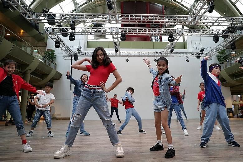 Performers from dance group Danz People rehearsing yesterday at The Pavilion in Far East Square during a costume check for this year's ChildAid.