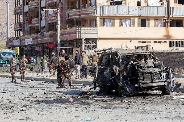 Afghan security forces inspecting the site of a car bomb attack, which targeted an armoured vehicle that belonged to GardaWorld - a Canadian security company that saw four of its staff wounded in the attack - in Kabul on Wednesday. PHOTO: EPA-EFE