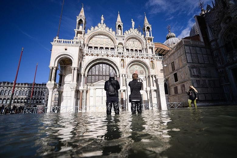The flooded St Mark's Square, including St Mark's Basilica (centre), on Thursday in Venice. Much of Venice was left underwater after the highest tide in 50 years ripped through the historic Italian city, beaching gondolas, trashing hotels and sending