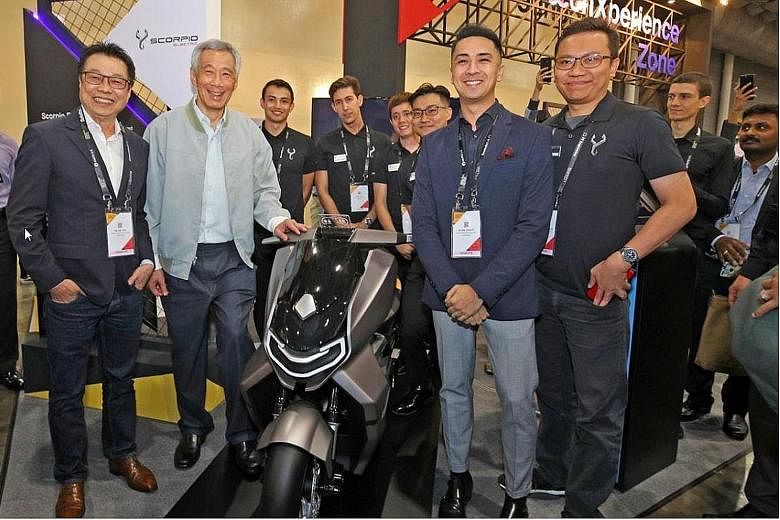 (From left) Mr Melvin Goh, chief executive of Scorpio Electric, Prime Minister Lee Hsien Loong, KTM Asia Managing Director Julian Legazpi and Acting Head of Operation at Scorpio Electric Muhammad Taureza posing with the scale model of the Scorpio EST