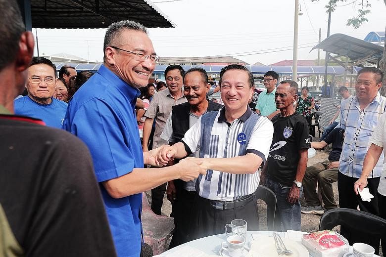 Tanjung Piai Bersatu division chief Karmaine Sardini (centre), Pakatan Harapan's candidate for the ward's by-election, being greeted by supporters after Friday prayers at Masjid Jamek Datuk Haji Noh Gadot Serkat in Johor yesterday. Former Umno vice-p