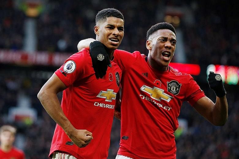 Marcus Rashford (left) celebrating scoring United's third goal in their 3-1 win over Brighton in the Premier League last Sunday with Anthony Martial. 