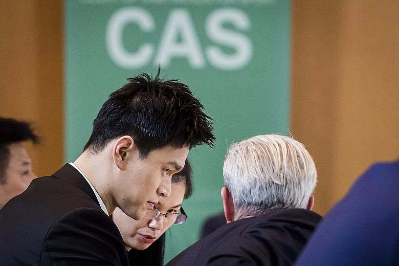 Chinese swim star Sun Yang listening to his lawyers during the Court of Arbitration for Sport hearing into a doping appeal by the World Anti-Doping Agency in Montreux yesterday. 