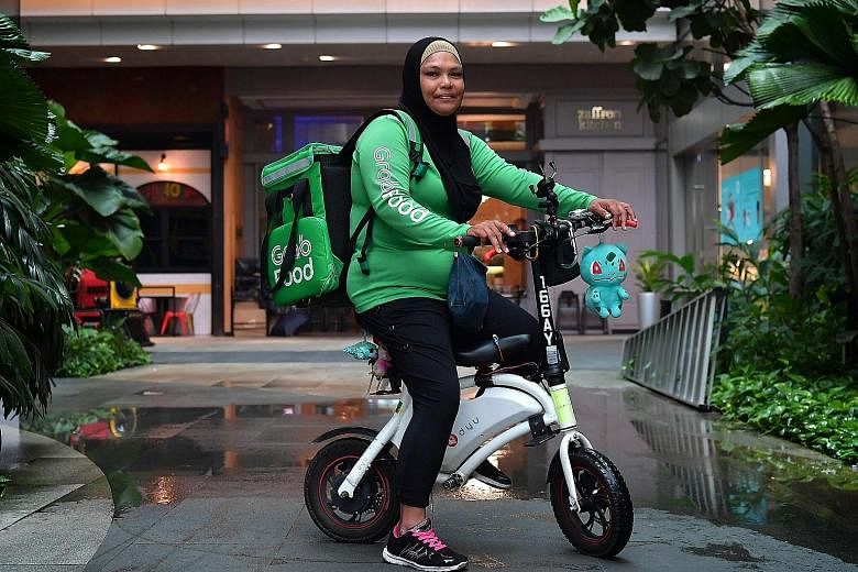 Being a GrabFood delivery rider lets Madam Afidah Amat structure work around ferrying her children to and from school.