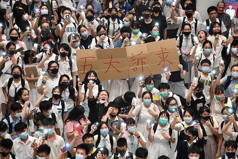 Young demonstrators in New Town Plaza belting out Glory To Hong Kong after taking part in a protest along the Shing Mun River near Sha Tin MTR Station on Sept 19.