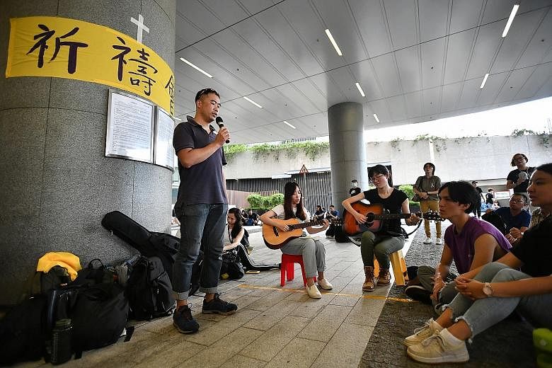 Protesters singing the hymn Sing Hallelujah To The Lord at the Legislative Council Complex on June 20.