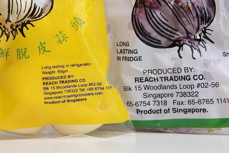 Top: Reach Trading imports raw garlic from China and shallots from the Philippines. They are peeled in Singapore and then labelled "Product of Singapore". Above: These milk labels say "Product of Singapore", but do not indicate where the raw milk com