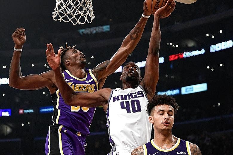 Los Angeles Lakers centre Dwight Howard (left) blocking a lay-up by Sacramento Kings forward Harrison Barnes during their NBA game at Staples Centre on Friday. The Lakers won 99-97 for their 10th win in 12 games this season. 