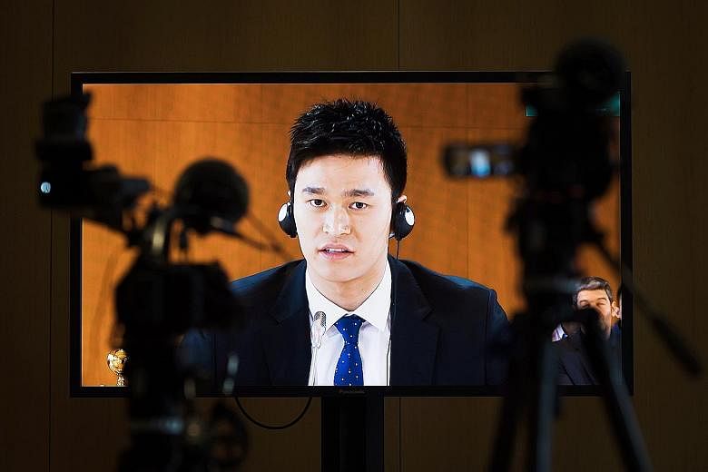 Sun Yang is pictured on a TV screen during the public hearing on Friday. The CAS will deliberate and set out its decision on a later date. 