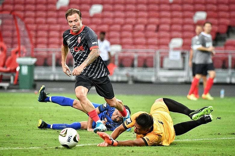 Manchester Reds' Michael Gray beating the Singapore Reds' defence to score in their 2-0 win which set up the final against Liverpool Reds. 