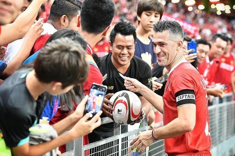 Liverpool Reds captain Luis Garcia obliging the fans after his team beat Manchester Reds 1-0 in the final at the National Stadium yesterday.