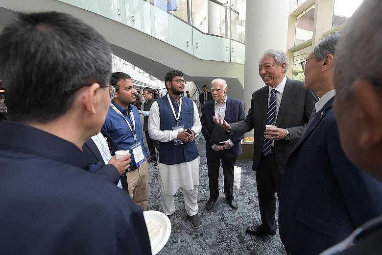 Senior Minister Teo Chee Hean interacting with some guests at the fourth South Asian Diaspora Convention held at the National University of Singapore's University Cultural Centre yesterday.