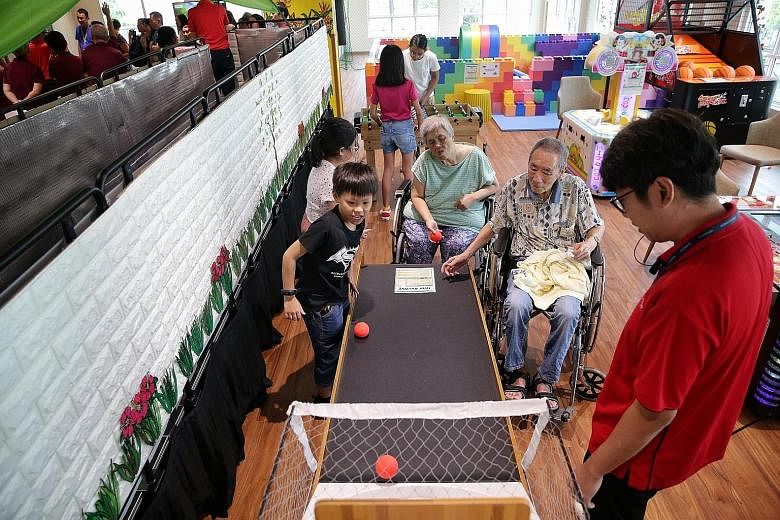 At the nursing home's Jade Circle Arena, seniors and children can play games such as mini bowling (above) or use the wading pool (left) together. ST PHOTOS: KEVIN LIM