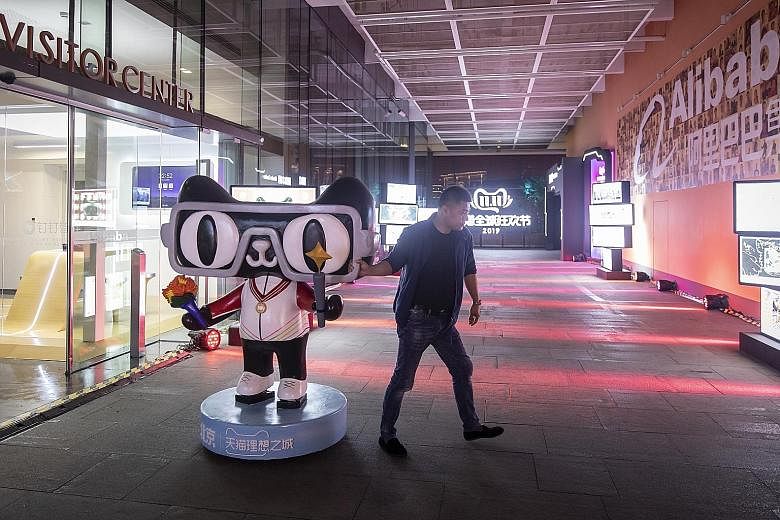 An employee moving a Tmall.com mascot at Alibaba's headquarters in Hangzhou. Alibaba's planned offering size for its initial public offering in Hong Kong has not changed as a result of the protests in the city, Mr Michael Yao, the company's head of c